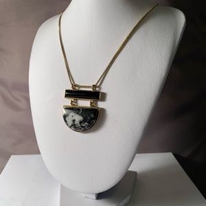 Gold colored necklace with black and white stones